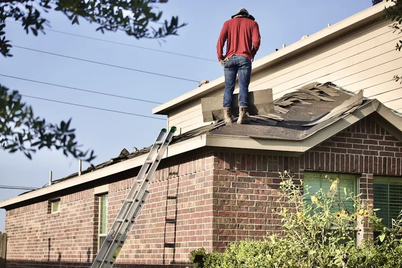 Professional roofer working on a residential roof in Downtown Marlborough